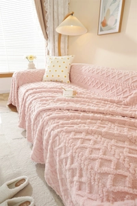 Close-up of soft pink thick plush sofa cover with elegant diamond jacquard pattern texture
