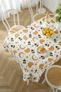 Close-up of waterproof polyester tablecloth with orange moon and star patterns