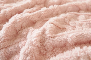 Close-up of soft thick pink plush sofa cover fabric with wave textured fleece patterns