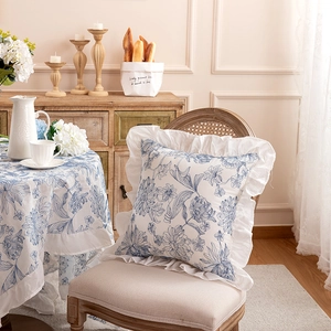 Detail of blue floral print pillowcase with elegant white ruffled edges in French style