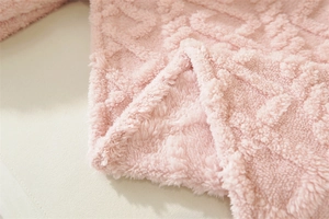 Close-up of pink thickened plush sofa cover with soft 3D jacquard geometric texture