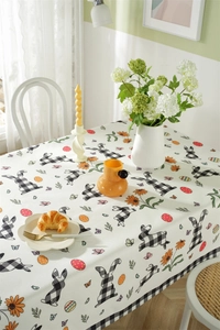 Detail of waterproof Easter tablecloth featuring plaid bunnies and floral spring patterns