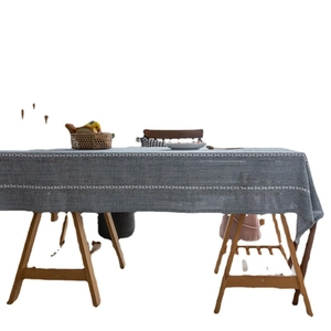 Blue geometric jacquard rectangular tablecloth with white braided hollow patterns on wood table