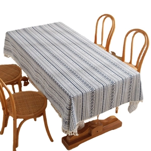 Bohemian blue and white geometric tablecloth with elegant white tassels on a dining table