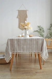 Macro shot of Nordic polyester jacquard tablecloth with vertical stripes and white tassels