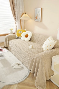 Detail of beige sofa cover featuring a 3D diamond jacquard weave texture and thick plush fabric