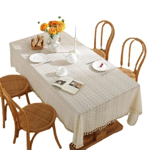 Beige lace tablecloth with geometric hollow patterns and handmade tassel fringe for dining decor