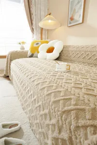 Close-up of thick beige plush sofa cover with detailed geometric diamond jacquard texture