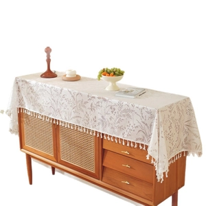 French country style beige lace table runner with floral patterns and delicate tassels