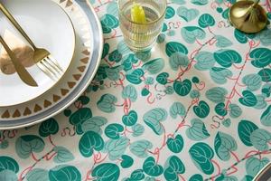 Close-up of cotton tablecloth with green leaf print and delicate ruffled edge detail