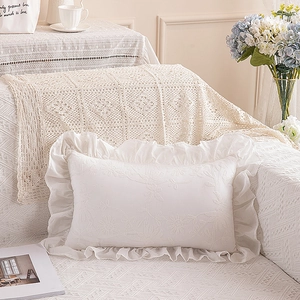 Detailed embroidery of 3D flowers on a white French ruffle edge decorative pillowcase
