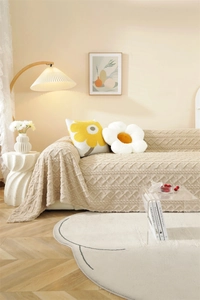 Detail showing plush beige jacquard sofa cover with 3D rhombus pattern and soft texture