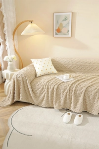 Close-up of thick plush cream sofa cover featuring elegant jacquard wave pattern texture