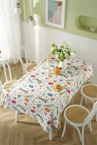 Detailed top view of Easter tablecloth with floral rabbit pattern on a long dining table