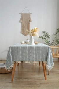 Close-up of blue polyester jacquard tablecloth with white stripes and fringe tassels