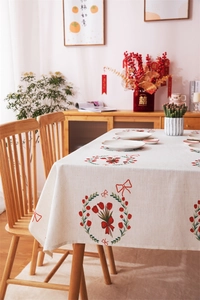 Close-up of red tulip wreath prints on linen-textured tablecloth for home dining