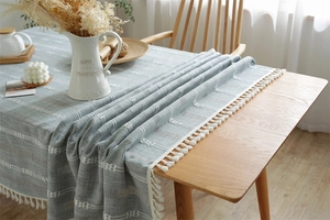Close-up of light blue jacquard tablecloth with Nordic fringe details and woven texture
