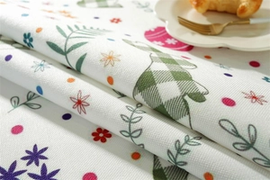 Detail of waterproof Easter tablecloth featuring rabbit and floral print on woven fabric