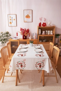 Detail of red tulip floral pattern and bow design on elegant festive dining tablecloth