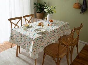 Detailed view of the ruffle edge on floral cotton tablecloth with strawberry pattern