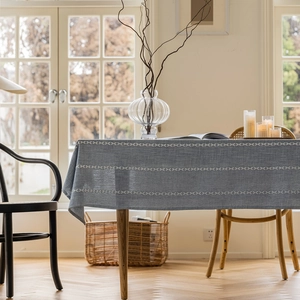 Blue textured rectangle tablecloth with white geometric pattern in a modern home setting