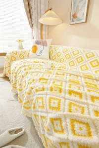 Close-up of yellow and white geometric diamond jacquard plush sofa cover texture