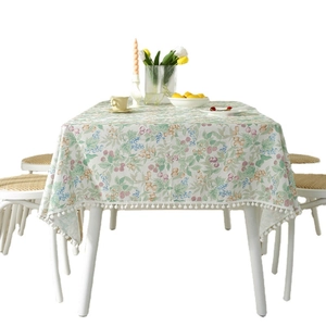 Floral cotton tablecloth with berry prints and white pom-pom fringe for home dining decor