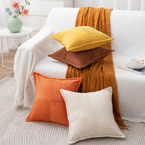 Corduroy square cushion covers with cross-stripe pattern in warm yellow and brown tones