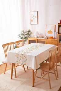 Detail of the elegant tulip print and green wavy edge on a modern linen tablecloth