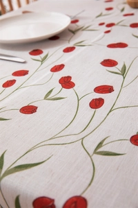 Detailed macro view of red tulip print on beige linen fabric tablecloth texture