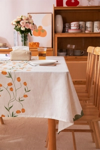 Detailed view of beige tulip floral tablecloth with thick linen texture and green piping