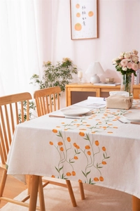 Detailed texture of cotton linen tablecloth with orange tulip digital floral printing