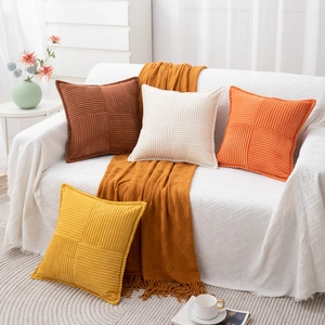 Detail of corduroy throw pillow covers with striped texture in warm autumn tones