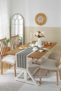 Detail of woven table runner featuring black and white geometric patterns and fringe tassels