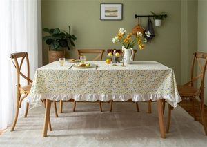 Close-up of yellow floral cotton tablecloth with elegant ruffled edge detail