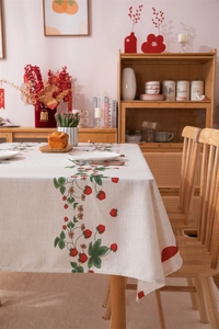 Detail of strawberry and vine print on beige rectangular cotton-linen tablecloth