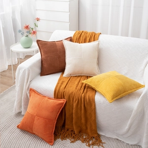 Detail showing corduroy striped patchwork texture of the cream style square cushion cover