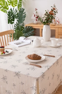 Detailed view of floral cotton tablecloth featuring tassels and elegant pastoral prints