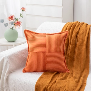 Detail of orange corduroy square pillowcase with cross-stitched textured ribbing