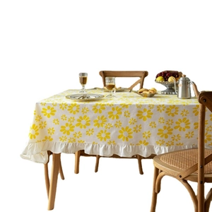 Floral cotton tablecloth with yellow daisy prints and ruffled edges for dining decor