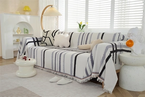 Close-up of waffle weave sofa cover featuring Nordic geometric prints and fringe details