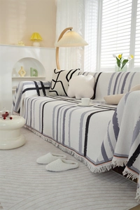 Detail of waffle weave texture and elegant fringe edges on a geometric sofa cover