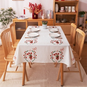 Red tulip and bow print tablecloth on a wooden dining table for home decoration