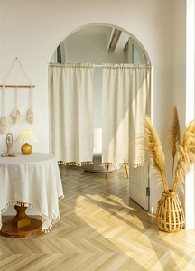 Detail of beige cotton linen door curtain with tassel trim for home partition