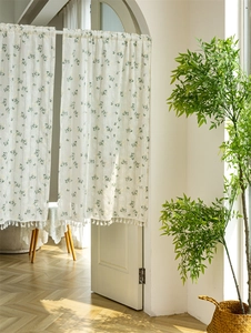 Detail of floral cotton curtain with white tassel fringe and fresh green flower patterns