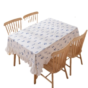 White cotton tablecloth with blue floral embroidery and pleated ruffle edges for dining tables