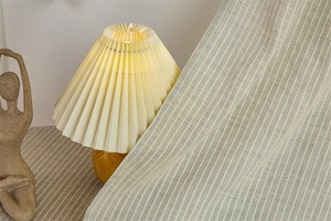 Detail of grey striped cotton door curtain fabric with soft home decor elements