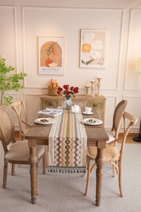 Detailed view of bohemian jacquard table runner with colorful wave patterns and tassels