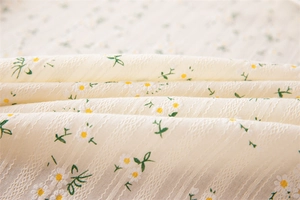 Detailed macro view of vintage cotton jacquard fabric with small daisy print and textures