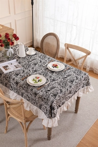 Detail view of monochrome butterfly jacquard tablecloth with pleated double-layer ruffled edges